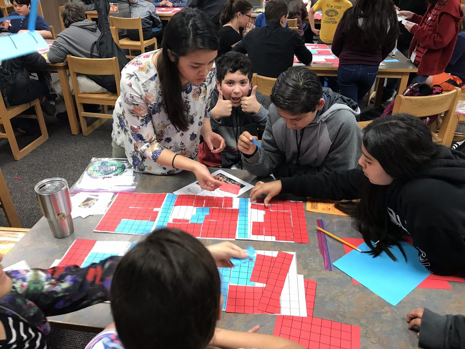 Students and their teacher planning a space-colony layout together